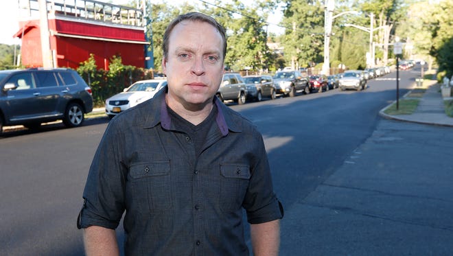 Nyack resident Kyle Ryan photographed on 5th Avenue in Nyack on Thursday, September 22, 2016.  Ryan, who lives near the hospital and has to deal with the parking on a daily basis says, "I'm not against them becoming a better hospital -  it will help make the town better. I'm against them expanding without providing the infrastructure with a parking deck."