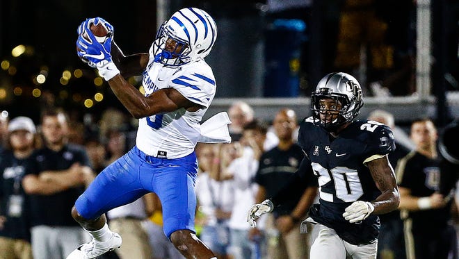University of Memphis receiver Phil Mayhue (left) grabs a completion in front of University of Central Florida defender Brandon Moore (right) during second quarter action in Orlando, Fl., Saturday, September 30, 2017.