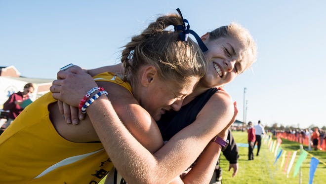Eastern York's Maddie McLain, left, and Dallastown's Emily Schuler embrace after finishing first and second, respectively, at the YAIAA Cross Country Championships at Gettysburg Area High School, Oct. 17, 2017. McLain finished with a time of 18:15.8 and Schuler finished at 18:16.8. 