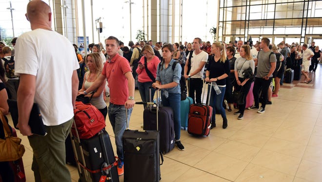 Tourists line up at to check in cat the airport of Egypt's Red Sea resort of Sharm El-Sheikh on Nov. 6, 2015.