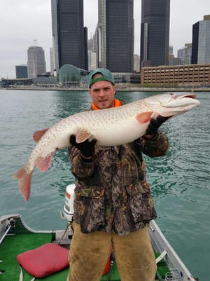 Joe Marquardt of Rochester, Mich., holds a 48-inch muskie caught in the Detroit River