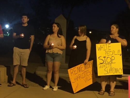 Kelly Devos holds anti-white-supremacy picket during a vigil.