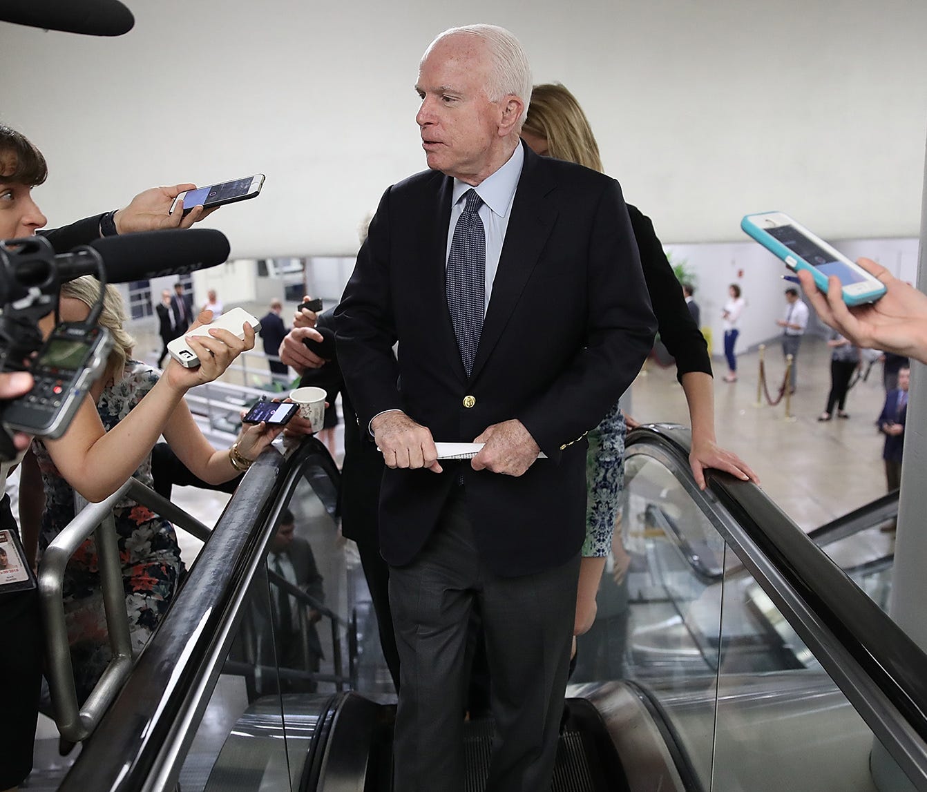 Sen. John McCain, R-Ariz., answers questions from reporters as he walks to a meeting of Republican senators July 13, 2017, in Washington, D.C. The Republican, who was diagnosed with glioblastoma on July 19,   2017, returns to Washington on Tuesday,   J