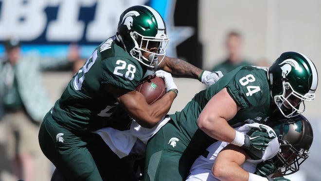 Michigan State running back Madre London runs the ball behind tight end Noah Davis during the spring game at Spartan Stadium on April 1, 2017.