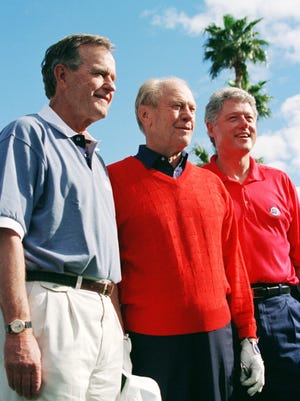 President Bill Clinton, right, is joined by  Presidents George H.W. Bush, left, and Gerald Ford for a formal portrait before beginning a round of golf together in the Pro-Am round of the Bob Hope Chrysler Classic in Indian Wells, California  Wednesday, Feb. 15, 1995.