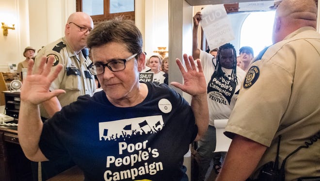 Pam McMichael (left) and Tayna Fogle (right) enter the state capitol to deliver their list of grievances to Governor Matt Bevin's office at the state capitol Frankfort, KY on Monday June 11, 2018.