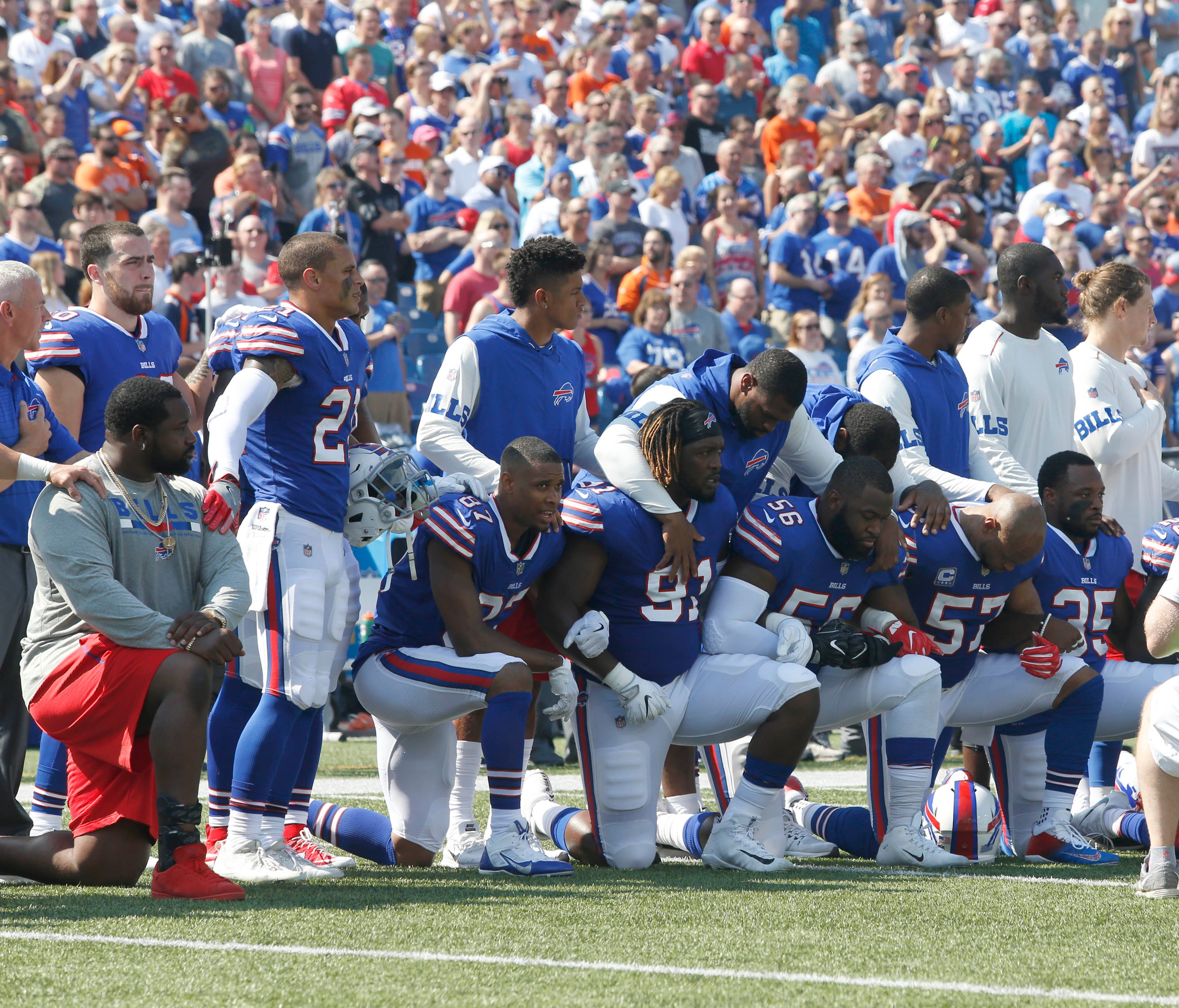 Buffalo Bills players kneel in protest during the National Anthem before a game against the Denver Broncos at New Era Field.