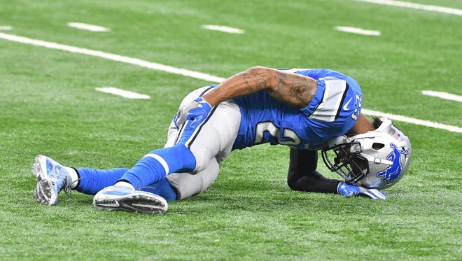 Lions cornerback Darius Slay grabs his leg after going down in the second quarter against Washington.