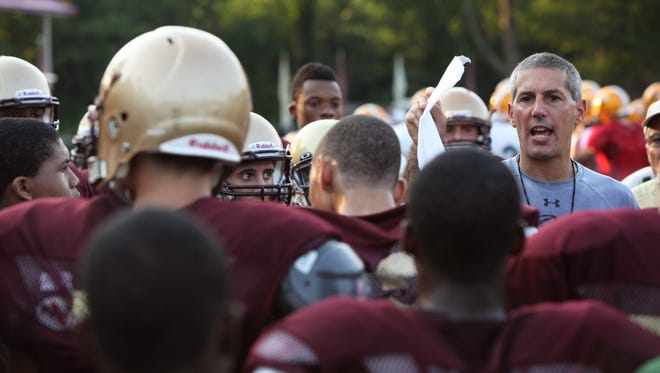 Iona Prep coach Vic Quirolo talks with his team during a football camp at Iona Prep in 2012. Quirolo, one of the most prominent coaches in the Lower Hudson Valley, resigned after 12 seasons as head coach.