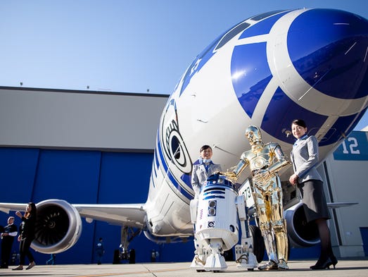 Star Wars characters R2-D2 and C-3P0 pose with All