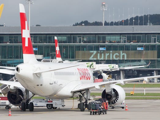 A Swiss International Bombardier CS-100 jet is readied