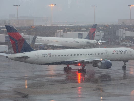 Delta Air Lines jets move at airport amid wintry conditions