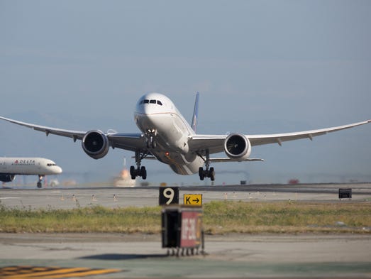Wings flexing, a United Airlines Boeing 787 takes off