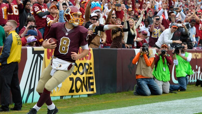 Washington Redskins quarterback Kirk Cousins (8) celebrates after scoring a running touchdown during the second quarter against the Tampa Bay Buccaneers at FedEx Field.