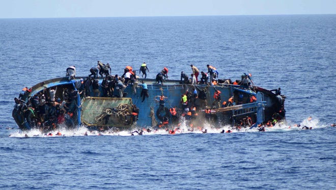 This handout picture released by the Italian Navy shows the shipwreck of an overcrowded boat of migrants off the Libyan coast on May 25, 2016.