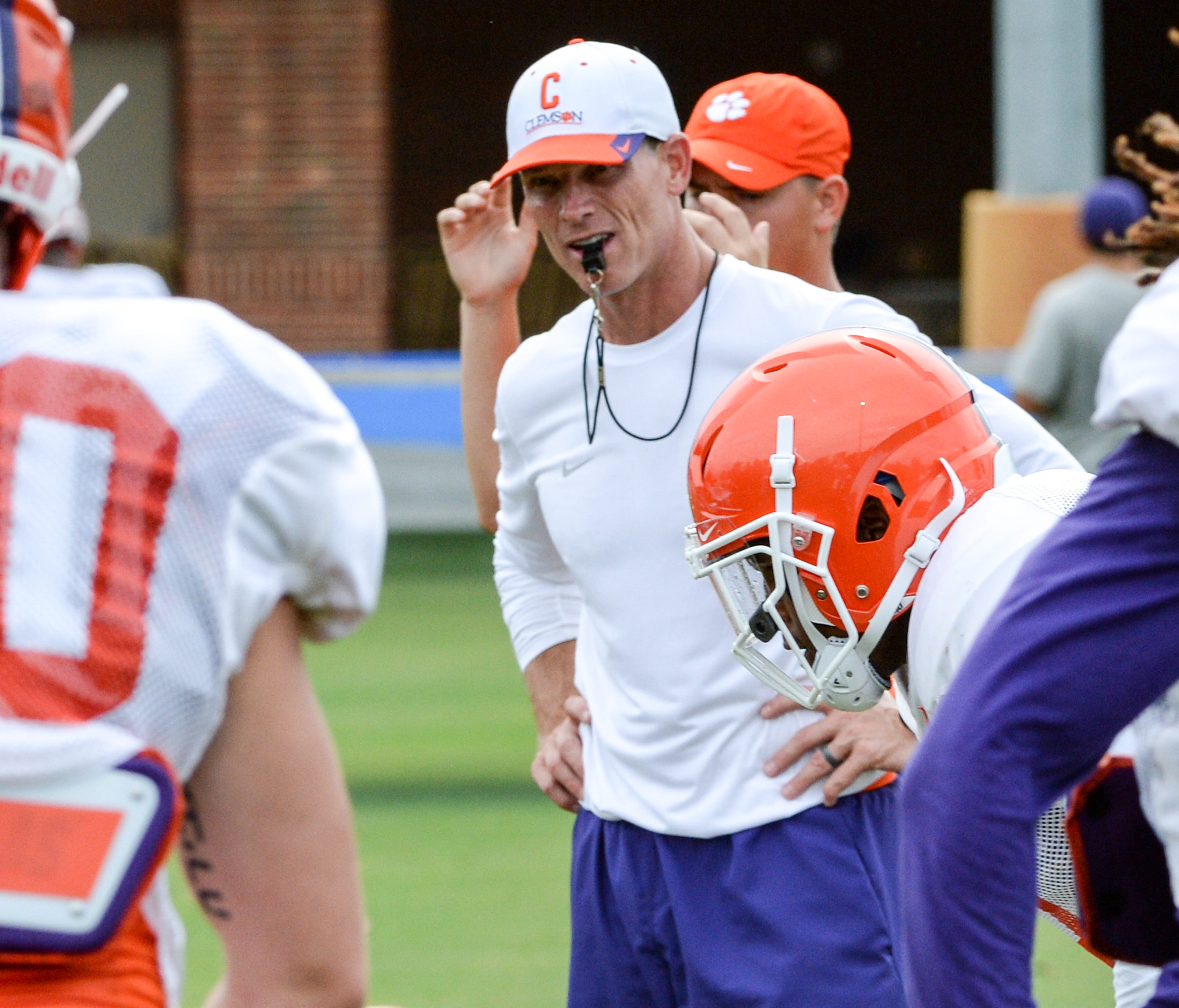 Clemson defensive coordinator Brent Venables runs a drill with linebackers during preseason football practice in Clemson on Tuesday.