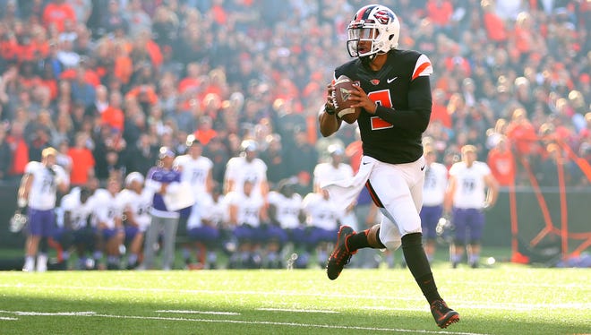 Oregon State quarterback Marcus McMaryion (3) rolls out to pass Oregon State against Weber State at Reser Stadium, Friday, September 4, 2015, in Corvallis, Ore.