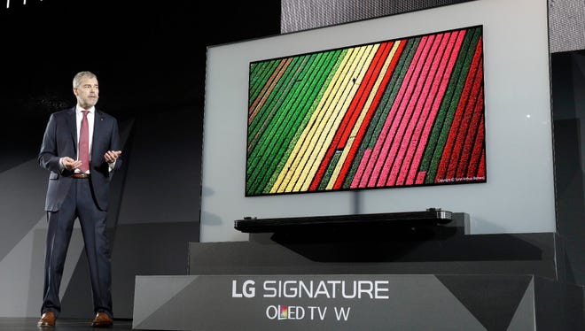 David VanderWaal, vice president of marketing for LG Electronics USA, unveils the LG Signature OLED TV W during an LG news conference before CES International, Wednesday in Las Vegas.