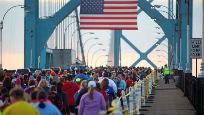 Runners run across the Ambassador Bridge during the 36th Annual Detroit Free Press / Talmer Bank Marathon in Detroit on Sunday, Oct. 20, 2013.