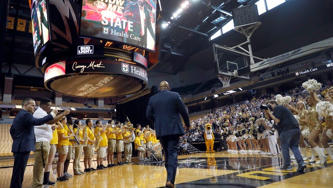 Cuonzo Martin walks past a pep band and cheerleaders to be formally introduced to fans as the new men's basketball coach at Missouri, Monday, March 20, 2017, in Columbia, Mo. Martin spent the past three seasons as coach at California and comes to Missouri with hopes he can revive the struggling program. (AP Photo/Jeff Roberson)