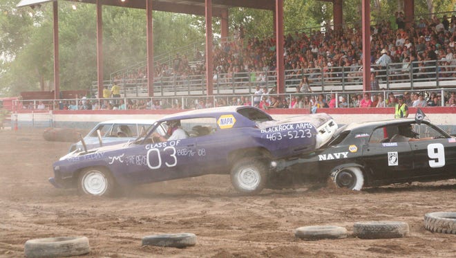 A hit in the first heat at the 2013 Demolition Derby at the Lyon County Fair left the car at left atop his opponent’s trunk before another car knocked it off with a hit.