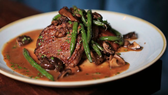 Le Moo's Steak Diane is pan-seared top sirloin with bourbon-sauteed mushrooms with skillet mashed potatoes with a bourbon-veal glace. $28.  Sept. 10, 2015