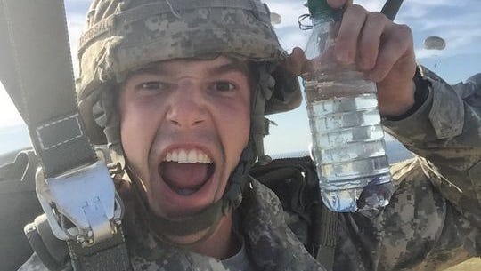 Spc. Matthew Tattersall with his fish Willy MakeIt. The soldier poked holes in a water bottle for a makeshift fish tank.