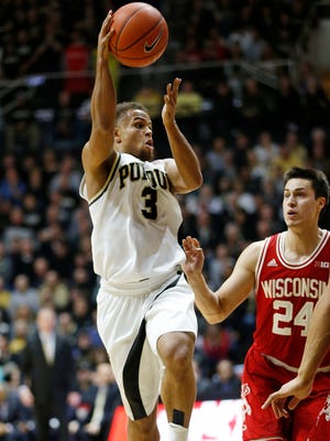 P.J. Thompson loops a pass over Bronson Koenig of Wisconsin Sunday, March 6, 2016, at Mackey Arena. Purdue defeated Wisconsin 91-80.