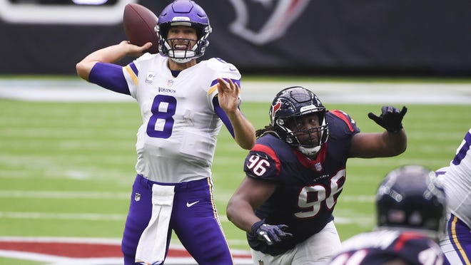 Minnesota Vikings quarterback Kirk Cousins (8) throws a pass while getting pressure from Houston Texans defensive end P.J. Hall (96) during the second half of an NFL football game Sunday, Oct. 4, 2020, in Houston.