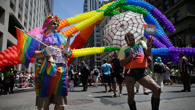 Participants in the Gay Pride Parade prepare to march in New York City in 2014. Fifth Avenue became one big rainbow as thousands of participants waving multicolored flags made their way down the street for the city's annual Gay Pride march.