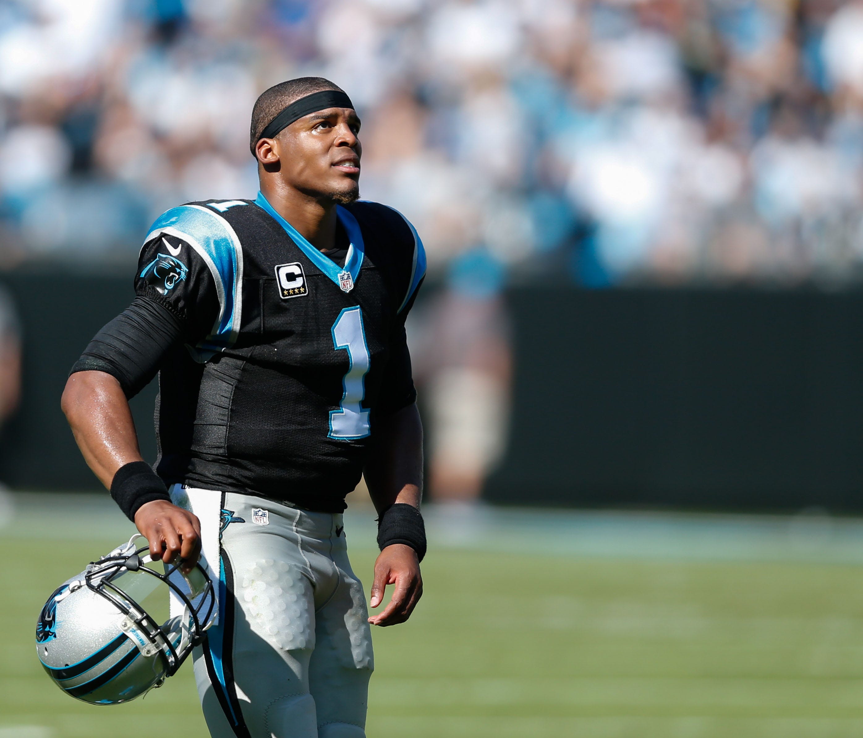 Carolina Panthers quarterback Cam Newton (1) stands on the field during a timeout in the second quarter against the Arizona Cardinals at Bank of America Stadium.