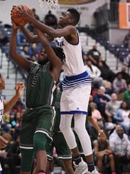 Teaneck's Pierre Sow battles for a rebound with Newark