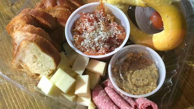 When you visit Flat 12 Bierwerks, order a snack plate at Hoagies and Hops, a sandwich shop inside the brewery.