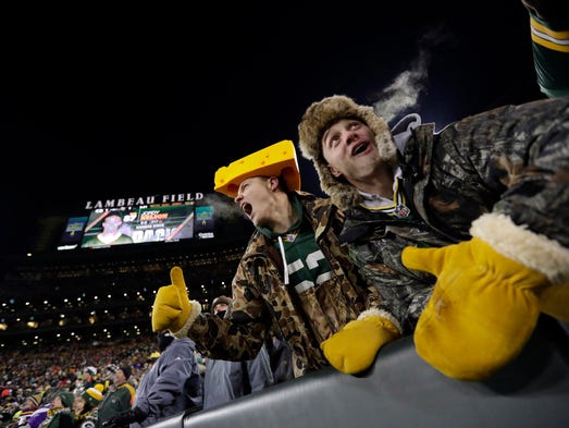 Green Bay Packers fans cheer at Lambeau Field.