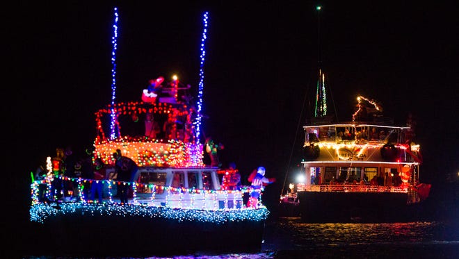 Boats make their way down the parade line to put on a show for the judges during the Naples Boat Parade on Saturday, December 10, 2016 in the city of Naples. Boaters were encouraged to decorate their boats along with the "super hero" theme for the 27th annual parade. 