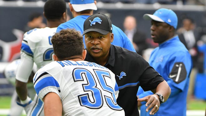 Lions coach Jim Caldwell shakes hands with his players before the game.