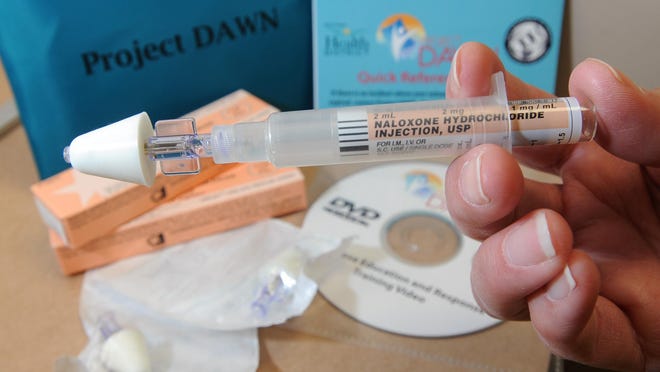The Project DAWN kit contains a reference guide, two doses of naloxone with two applicators and two atomizer attachments.