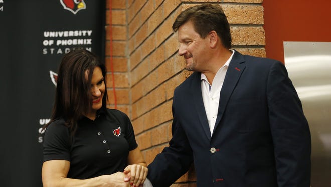 Dr. Jen Welter shakes hands with Cardinals team President Michael Bidwill after being introduced during a press conference at the team's training facility in Tempe July 28, 2015. She is the first female coach in the NFL and will be a Cardinals coaching intern for training camp and the preseason.
