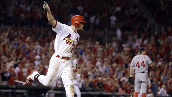 The Cardinals' Brandon Moss celebrates after hitting a walk-off three-run home run off Washington Nationals relief pitcher Casey Janssen (44) during the ninth inning on Tuesday night.