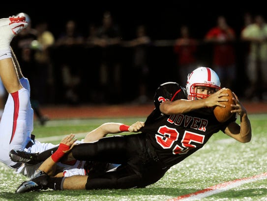 Dover's Isaiah Green is brought down by a Red Land