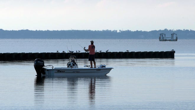 A lone angler tries his luck catching fishing near the 17th Ave. boat ramp Wednesday morning.
