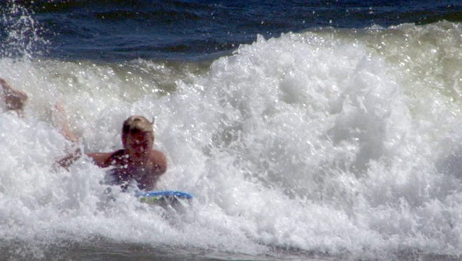 A boogie boarder catches a wave in the surf on the final day of the summer in Seaside Park Monday afternoon, September 7, 2015.  