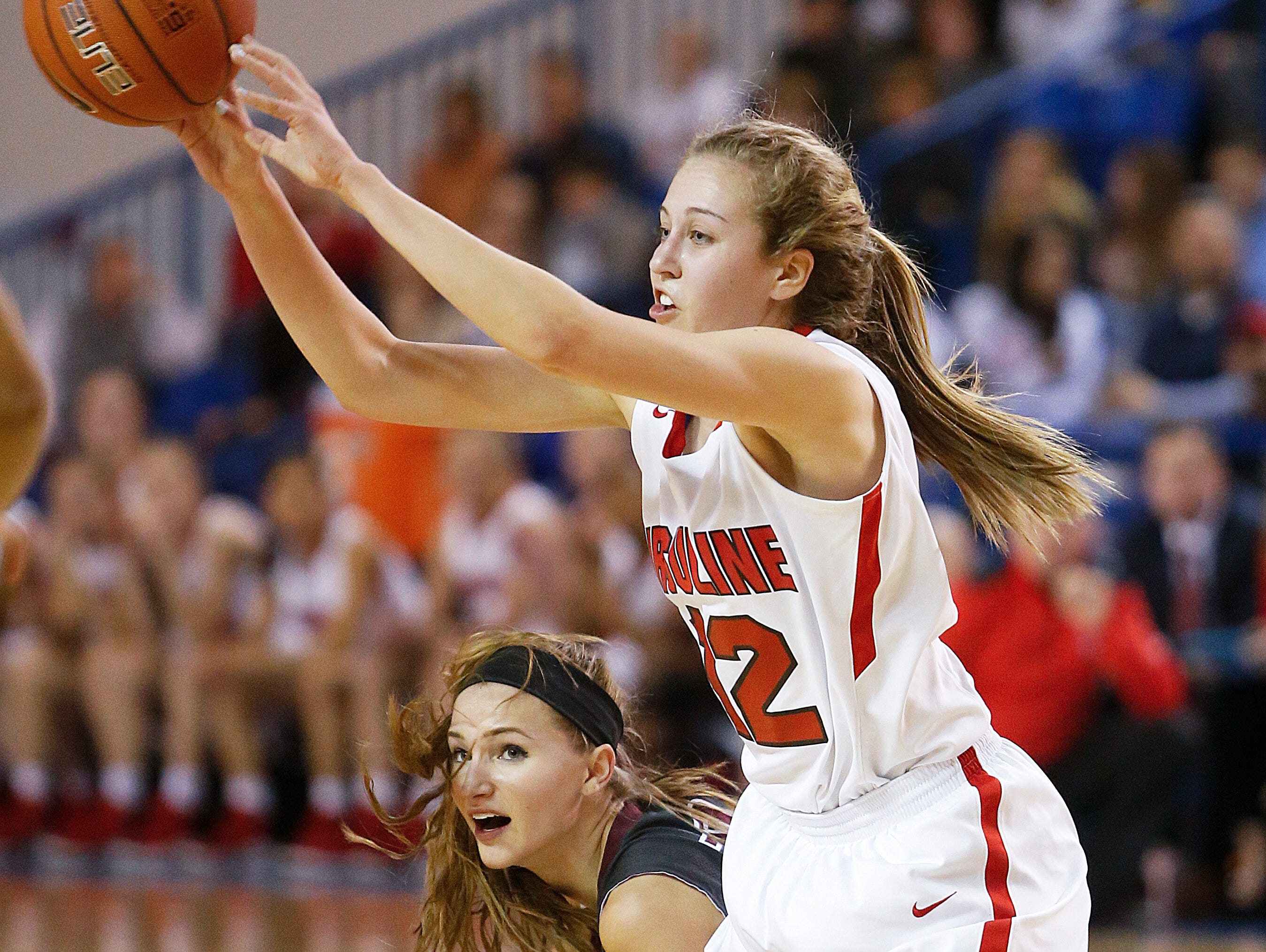 Ursuline's Oliva Mason comes away with the ball after a struggle with Caravel's Grace Lange in the first half of the Raiders' 54-32 win in the DIAA state tournament title game at the Bob Carpenter Center Friday.
