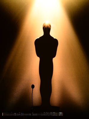 An image of an Oscar statuette is seen in the background.