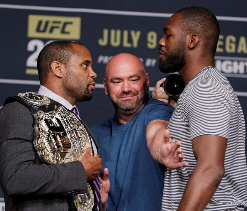 Dana White, center, stands between Daniel Cormier, left, and Jon Jones during a UFC 200 mixed martial arts news conference, Wednesday, July 6, 2016, in Las Vegas. Cormier and Jones are scheduled to fight in a light heavyweight championship fight at U