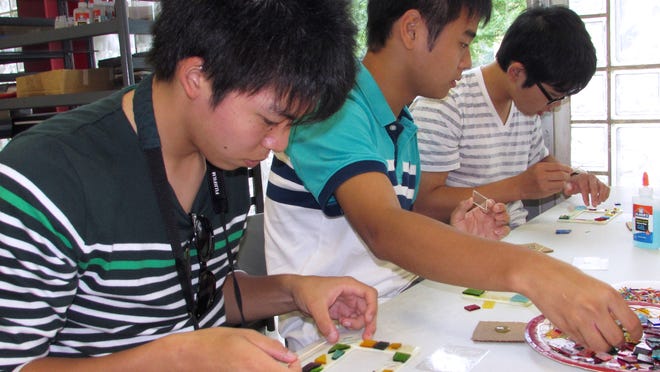 
Students from Corning's sister city Kakegawa, Japan make glass pieces Thursday at the Corning Museum of Glass. 
