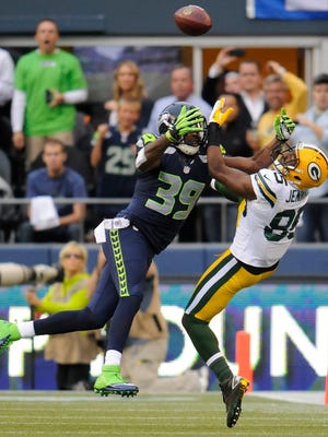 Packers receiver Greg Jennings (85) tries to catch a pass with Seahawks defender Brandon Browner closing in during the teams’ Sept. 24, 2012 game in Seattle. The Seahawks secondary’s physical style of play has prompted the league to take a closer look at holding and illegal use of hands violations.