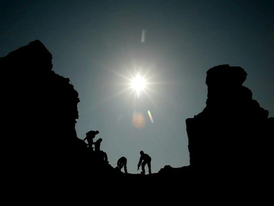 Iraqi children run inside an ancient temple in the