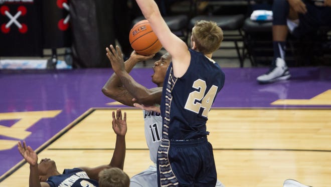 GCU's De'Andre Davis (11) draws a foul on Montana State's Michael Dison (3) as Eric Norman (24) goes up for a block in GCU's 61-45 win on Nov. 17, 2014.