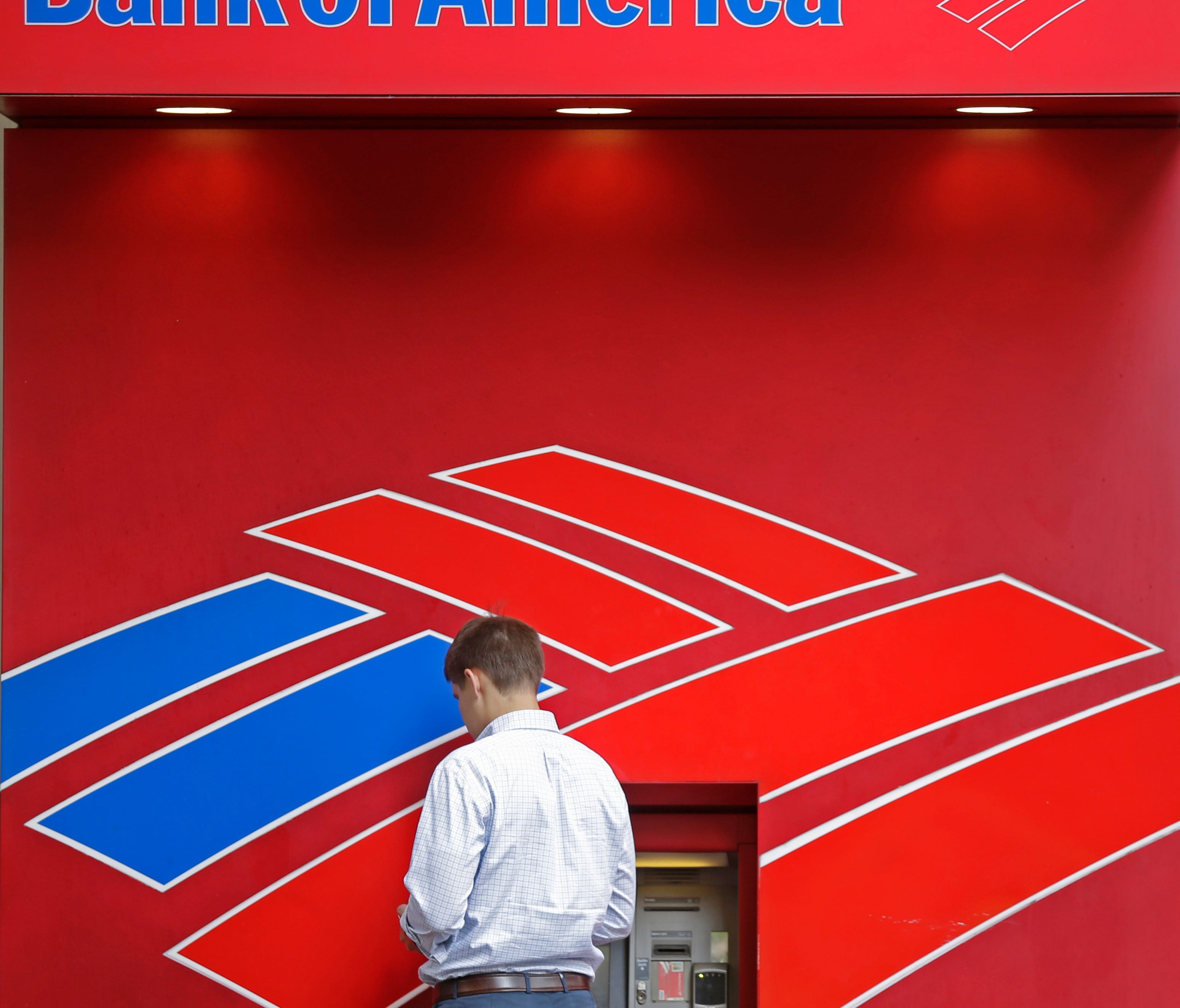 A customer uses a Bank of America ATM near the company's headquarters in Charlotte, N.C., Tuesday, July 7, 2015.